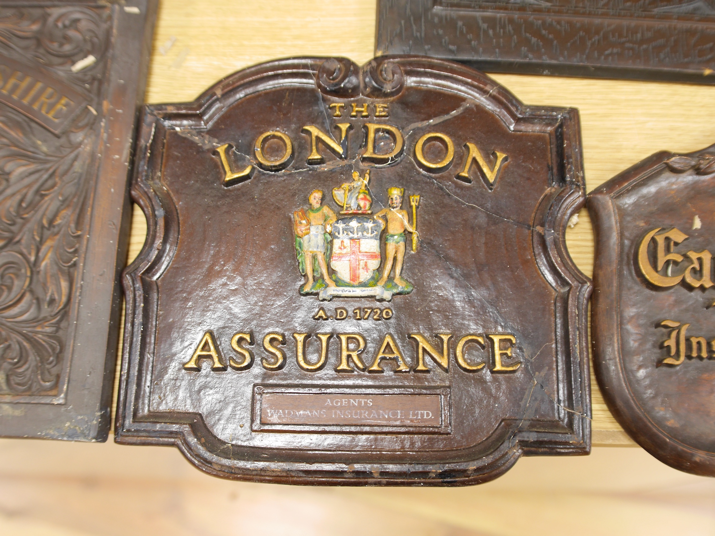 Seven insurance plaques to include The Yorkshire Insurance company and Alliance Insurance Company, largest 46cm high. Condition - varies